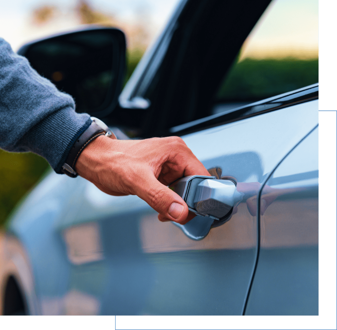 local-expert@2x A person wearing a long-sleeve shirt and a watch opens a car door.